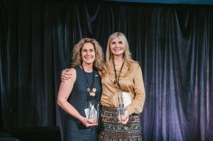 Image of Rising Star Sarah Hampel standing alongside 50k Club Member Caroline Hope Light, both smiling and posing together in a celebratory setting