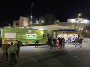 The Lime Truck and The Tropic Truck deliver hot meals with Roaming Hunger to first responders at the Rose Bowl during the LA Fires.