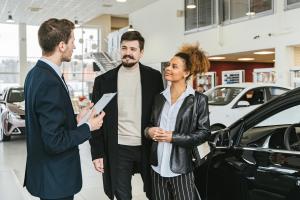 A man and a woman shopping for a car at a dealership