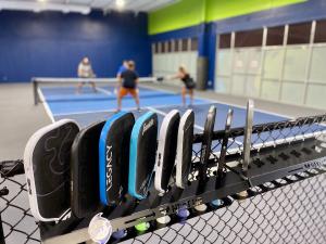 Close up of pickleball paddles and players at indoor facility, Mandeville, LA.