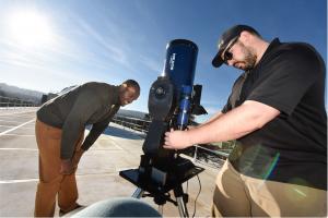 U.S. Navy Lt. Jibri Kea (left) and Kurt Heyde (right) configure tracking software for telescope to follow the Otter CubeSat to test optical communications to a ground station.