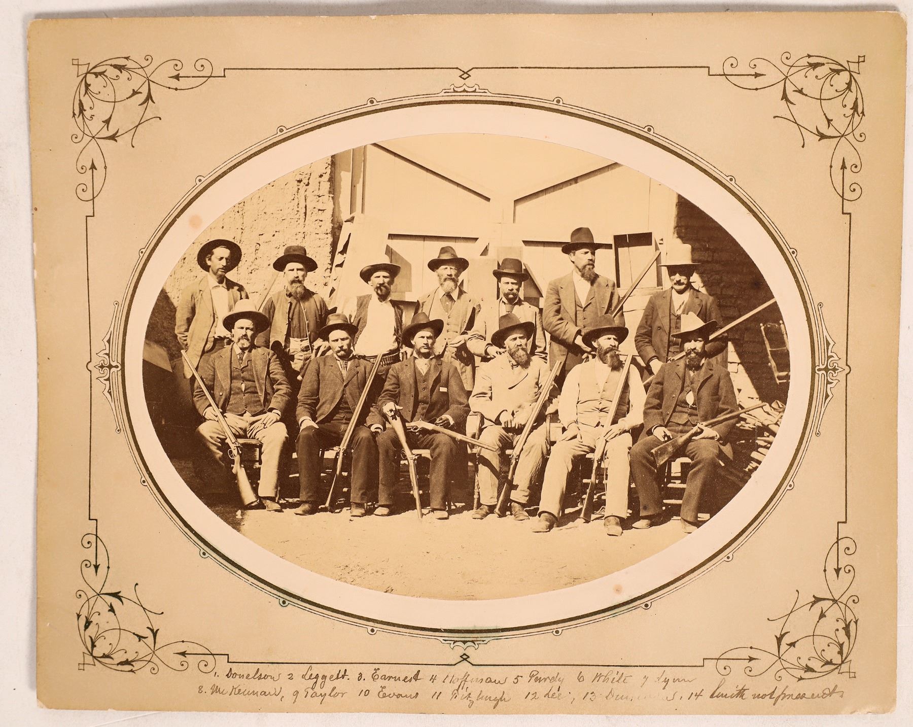 Mounted original albumen photo from 1881 of 13 men who made up a posse sent from Tucson to Yuma to take over the goods from a suspected huge retail goods swindle (est. $2,500-$7,500).