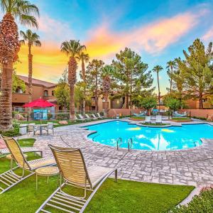 Pool and chaise lounges at Collage Apartments looking back towards the community.