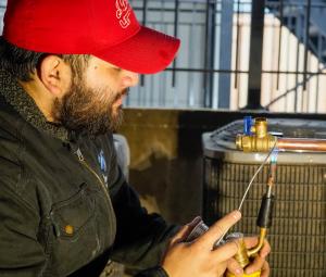 J. Blanton Plumbing technician conducting after-hours plumbing services, showcasing the company’s expertise in basement flooding prevention and winter plumbing maintenance for Chicagoland homes.