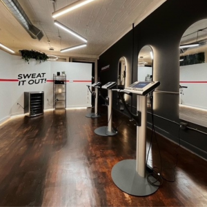 Depicting three high-tech EMS machines in the center of the Iron Bodyfit Chelsea studio in Manhattan, New York