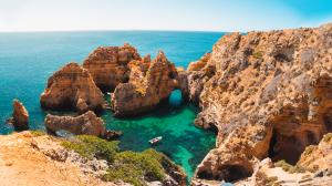 A breathtaking view of Ponta da Piedade, Portugal, showcasing its dramatic limestone cliffs, crystal-clear waters, and hidden sea caves.