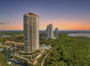 Luxury Bonita Springs condo with stunning Gulf and Bay views, dual balconies, a fireplace, outdoor dining with a gas grill, private en-suites, and upscale amenities.