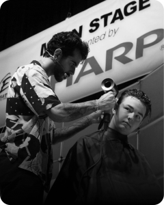 Professional barber cutting hair with precision during an online training session at LearnToCut.com, demonstrating fade and taper techniques.