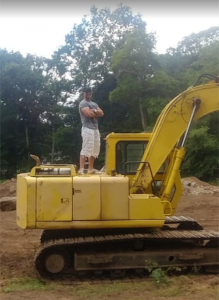 Robert Letskus of Refined Living, Inc. stands poised on a construction site, ready to transform undervalued land into profitable real estate ventures