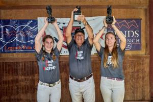 three arena polo players hold up their trophies