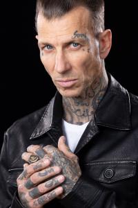 Michael R House from Beast Games wearing black leather jacket showing tattoos