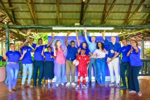 Make-A-Wish and TLM staff and volunteers with wish child Kuyela