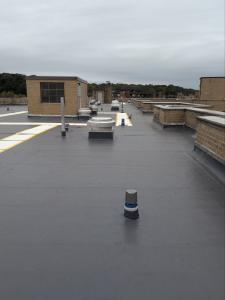 Industrial roof with walkpads to protect the roof around mechanicals on the roof