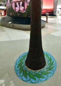 Decorative epoxy terrazzo design tree grates in precast terrazzo set around artificial trees in "the Springs" public art work in epoxy terrazzo at Orlando International Airport, the terrazzo Job of the year 2025. 