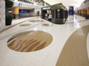 Epoxy terrazzo design: public art medallions in neutral colors represent local sand dunes and plants.