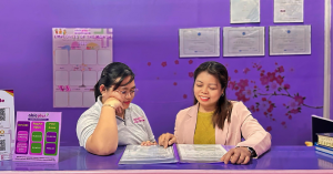 Two ladies reading books at Able Plus Life Skills Center