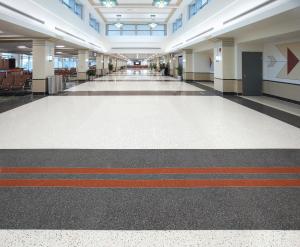 terrazzo design in airport corridor with gray and red bold lines.