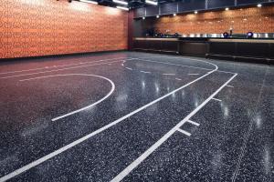 Terrazzo design: Black terrazzo with basketball-themed divider strip patterns