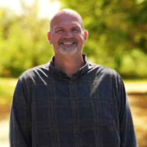 Photo of Ken Carroll, Co-Founder of Integris Design against a natural background.