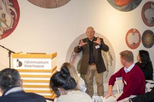 Meatable CEO Jeff Tripician speaks in front of a podium to a crowd of people.