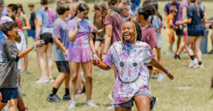 A camper enjoys time outside with her peers.