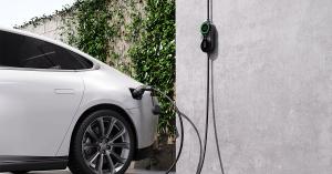 Tayniu Infinity 7kW Portable EV Charger mounted on a wall, charging a white electric vehicle.