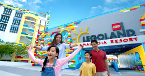 Family excited to be in LEGOLAND in front of it's sign