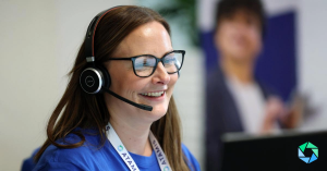 A member of Atamis' support team is shown on the phone with a client.