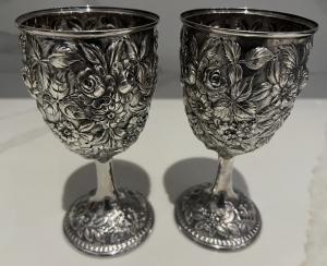 Pair of Kirk repousse 402F sterling silver goblets together totaling 16.4 troy ounces and each one about 6 ½ inches in height (est. $2,200-$2,500).