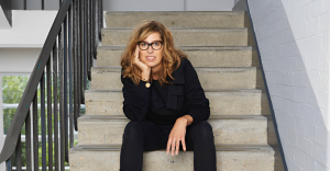 Photograph of Nina Marenzi sitting on a staircase