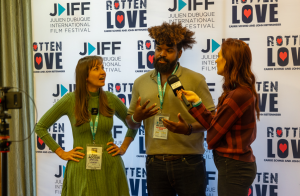 Three people on the red carpet doing interviews  at the Julien Dubuque International Film Festival