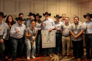 Texas A&M Students in black cowboy hats pose for a group photo