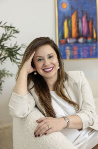 Female headshot with art in background