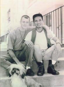 young men siting on front steps as a couple with small dog