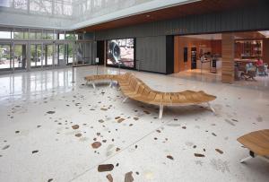Terrazzo design: floor with river rocks and brass leaves embedded.