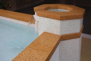 Terrazzo design: A baptismal font with terrazzo inside and out, white and tan. 