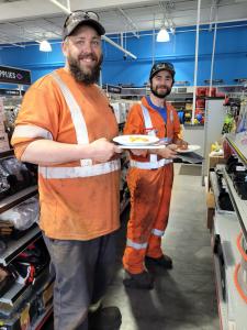 2 friends looking at products on shelving units