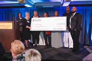 Korbex International's Check Presentation to Barbara Clemons' family with Judy Bannon at the 2025 Women of Achievement Awards.