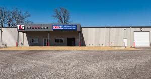 Gray metal building with The Larson Group and TRP logo.