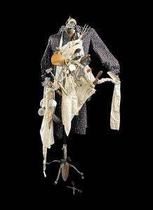 Artist: Anne Emmons. Design incorporates a dress belonging to her Great-Grandmother, a farm widow from southwestern Kentucky. Said Emmons, "While the original dress has no pockets, my concept for this exhibit is to illustrate the diverse aspects of her