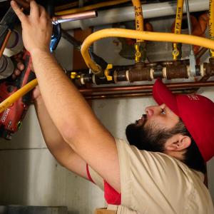 J. Blanton Plumbing technician working on a water heater installation service, highlighting the company’s trusted plumbing services in Evanston, including water heater maintenance and installation for spring readiness.