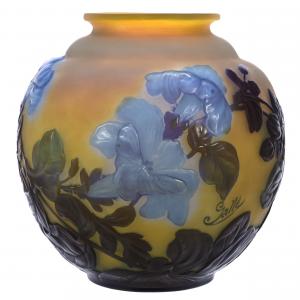 This bulbous French Cameo vase signed Galle in the Morning Glory pattern, 9 ½ inches tall, having a yellow ground with blue and green cameo cutback soufflé, sold for $7,000.