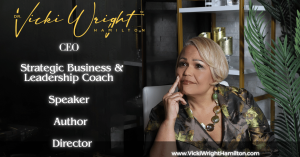 Dr. Vicki Wright Hamilton seated in a stylish, modern office setting with greenery and gold accents, showcasing her titles: CEO, Strategic Business & Leadership Coach, Speaker, Author, Director.