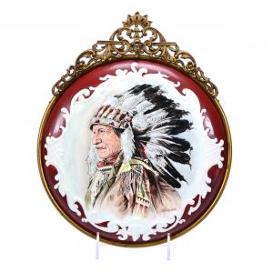 Round, unmarked Wave Crest plaque in a scroll mold and having a gorgeous hand-painted Native American Chief décor, mounted in an ornate gilt metal frame. Estimate: $2,500-$5,000