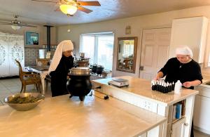 two sisters in the medicine making large kitchen in the abbey in california