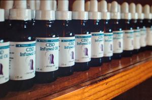 a row of bottled CBD oils made by the sisters, with the sisters of the valley logo