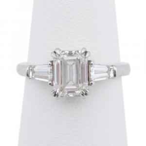 Diamond engagement ring in platinum, with an emerald cut diamond weighing 1.70 carats (VVS-1 clarity and G color), and two tapered baguette shape diamonds. Estimate: $8,000-$12,000