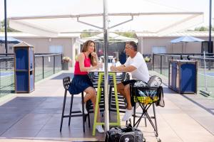 people eating at a pickleball court