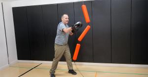 A senior uses the Jukestir Coordination Bag to improve balance, reflexes, and coordination—key elements in reducing falls and enhancing mobility for older adults.