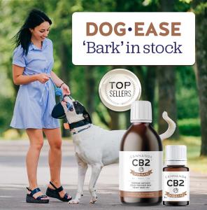 Dog-Ease "Bark" in stock: Best selling CB2 oil for dogs. Bottle of CB2 Dog-Ease. Young woman in short blue sun dress walking her dog